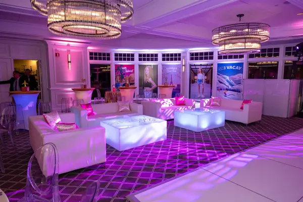 Sienna's Bat Mitzvah lounge with glowing tables and destination poster backdrops