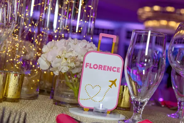 Sienna's Bat Mitzvah Florence suitcase table sign with hydrangea centerpiece