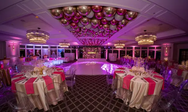 Sienna's Bat Mitzvah dance floor under pink and gold balloon ceiling