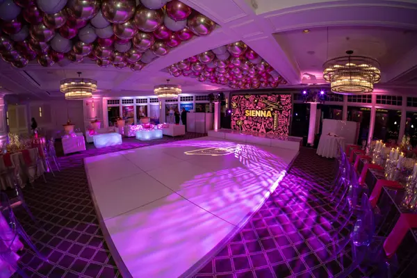 Sienna's Bat Mitzvah white dance floor with logo projection and balloon ceiling