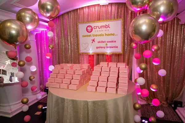 Sienna's Bat Mitzvah Crumbl cookie favor table with balloon garlands