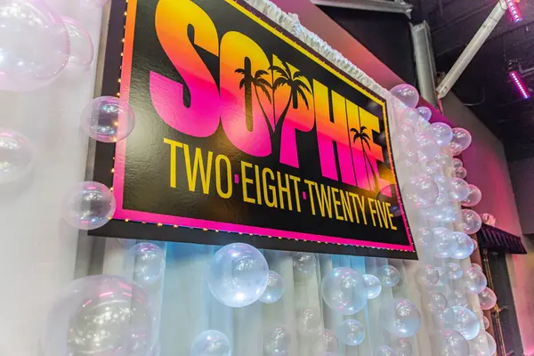 Close-up of the Sophie palm tree logo sign and bubble balloons