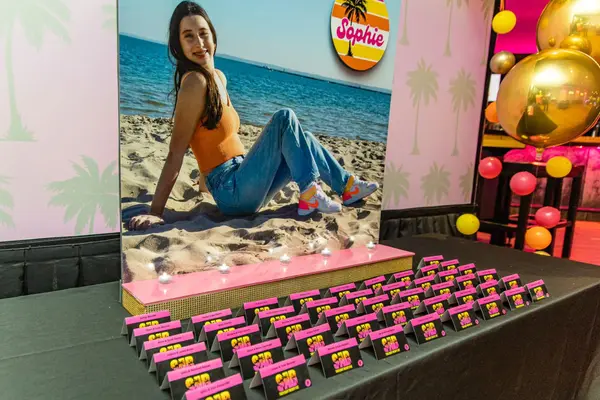 Sophie's Bat Mitzvah escort card table with beach photo display
