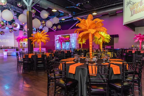 Orange feather palm centerpieces across the dining room at Sophie's Bat Mitzvah