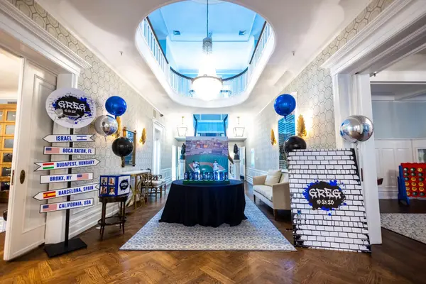 Entrance hall with directional sign, brick wall board and balloons