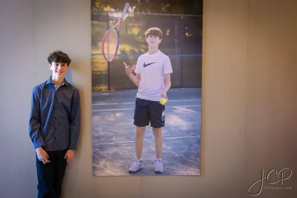 The honoree beside his life size tennis poster at Ryan's Bar Mitzvah