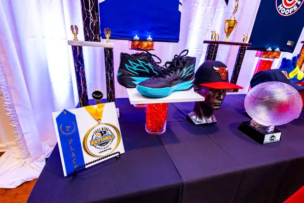 Sneakers, medal and caps on Mike's Bar Mitzvah Hall of Fame table