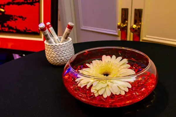 Floating white gerbera in a red gem bowl at Mike's Bar Mitzvah
