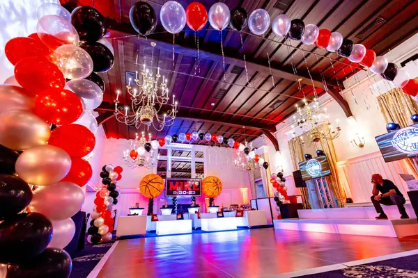 Red and black balloon arch framing Mike's Bar Mitzvah dance floor