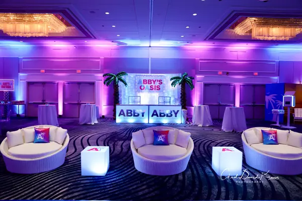 Round lounge seats and Abby's Oasis bar at Abby's Bat Mitzvah