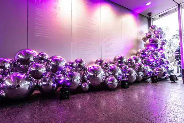 Chrome silver balloon installation with purple uplighting at Serena's Bat Mitzvah