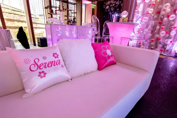 Serena custom logo pillows on a white lounge sofa