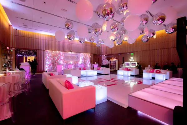Serena's Bat Mitzvah lounge, dance floor and balloon backdrop in pink light