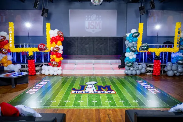 Jeremy's Bar Mitzvah football field dance floor wrap with balloon goal posts