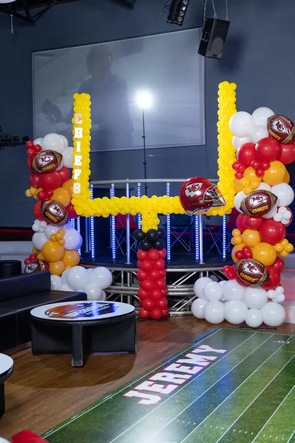 Chiefs balloon goal post with football helmet balloons at Jeremy's Bar Mitzvah
