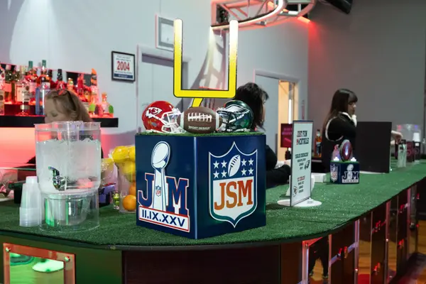 Logo cube bar centerpiece with mini helmets and goal post on turf
