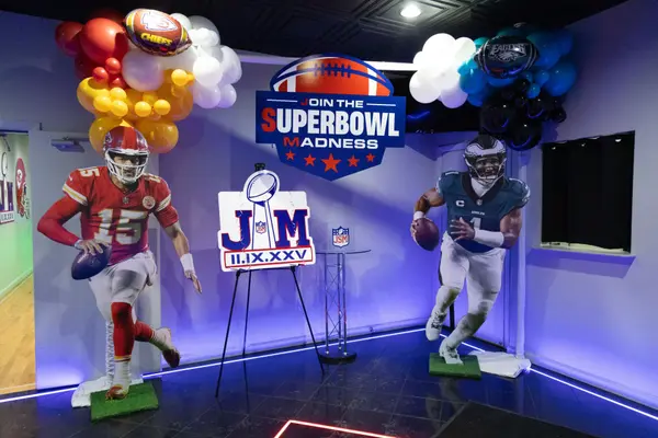 Life-size player cutouts and Super Bowl Madness sign at the entrance