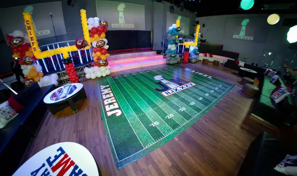 Football field dance floor and Chiefs balloon goal post from the lounge