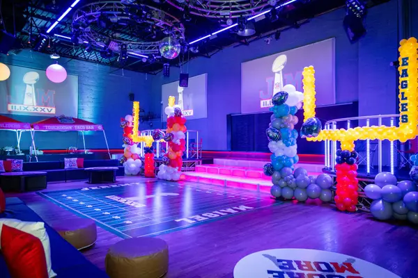 Purple-lit room with balloon goal posts at Jeremy's Bar Mitzvah