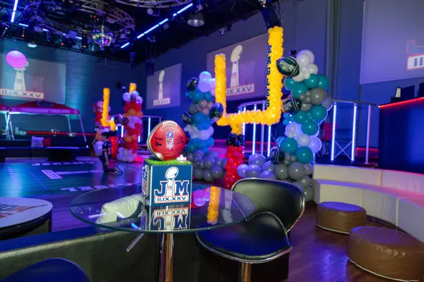 Football logo cube centerpiece on a glass high-top near the lounge