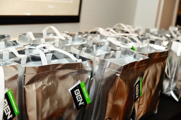 Silver gift bags with green Ben logo tags at Ben's Bar Mitzvah