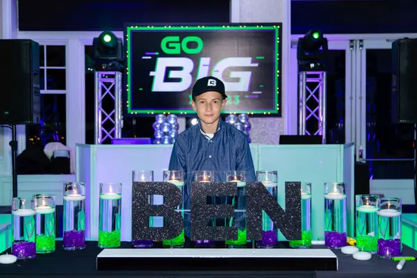 The honoree behind the candle lighting display at Ben's Bar Mitzvah