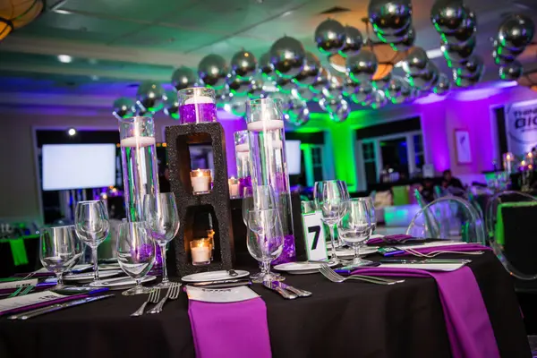 Purple table setting with glitter B centerpiece at Ben's Bar Mitzvah