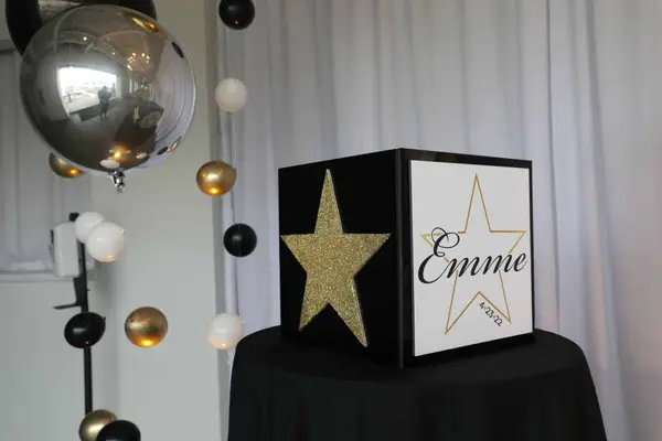 Emme's Bat Mitzvah gold star logo gift box with balloon strands