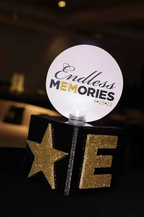 Endless Memories logo sign on a glitter star and letter cube