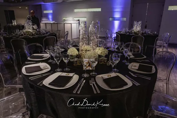 Black table setting with fairy light centerpiece at Emme's Bat Mitzvah