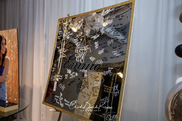 Signed Emme logo mirror sign-in board at the end of the night