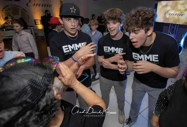 Guests in custom black EMME tees on the dance floor
