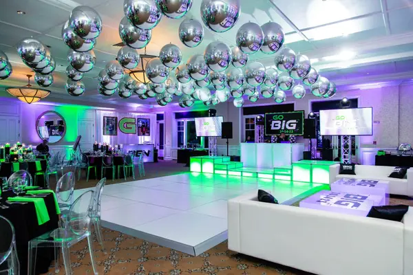 White dance floor and lounge at Ben's Bar Mitzvah under silver balloons