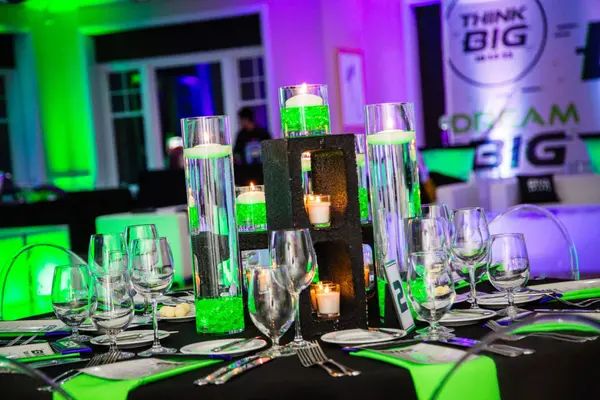 Cylinder centerpiece with green gems and candles at Ben's Bar Mitzvah