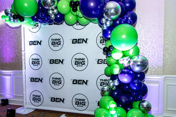 Ben step and repeat with green, navy and silver balloon arch