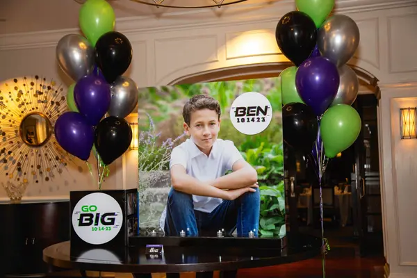 Life-size photo display with balloon bouquets at Ben's Bar Mitzvah