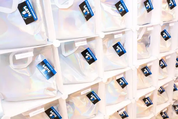 Owen's Bar Mitzvah holographic favor bags with logo tags in cubby wall
