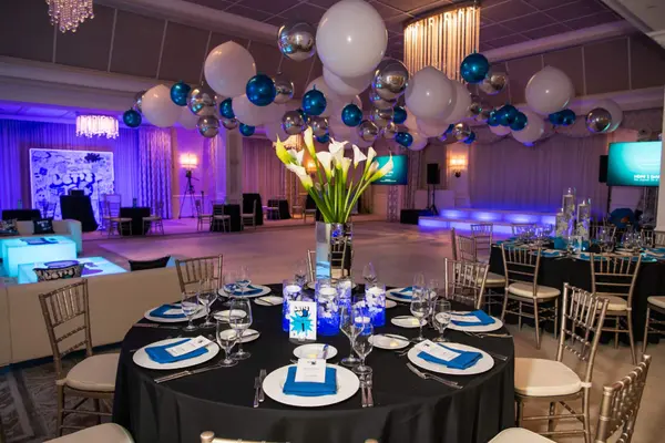 Owen's Bar Mitzvah dining table with calla lily centerpiece and balloon ceiling