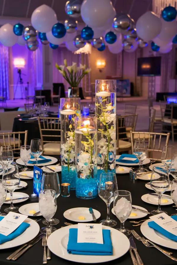 Owen's Bar Mitzvah floating candle cylinder centerpiece with white orchids
