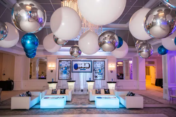 Owen's Bar Mitzvah lounge and logo backdrop under balloon ceiling