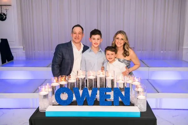 Owen's Bar Mitzvah candle lighting display with blue glitter letters