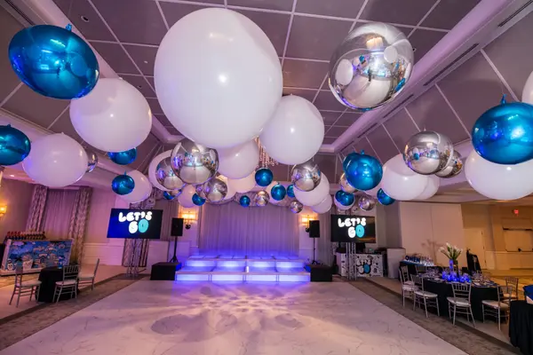 Owen's Bar Mitzvah dance floor with oversized balloon ceiling and lit stage