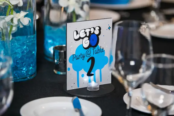 Owen's Bar Mitzvah Let's Go table number card on a dining table