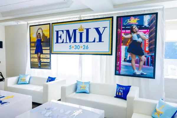 Emily's Bat Mitzvah logo sign backdrop with life size posters and lounge