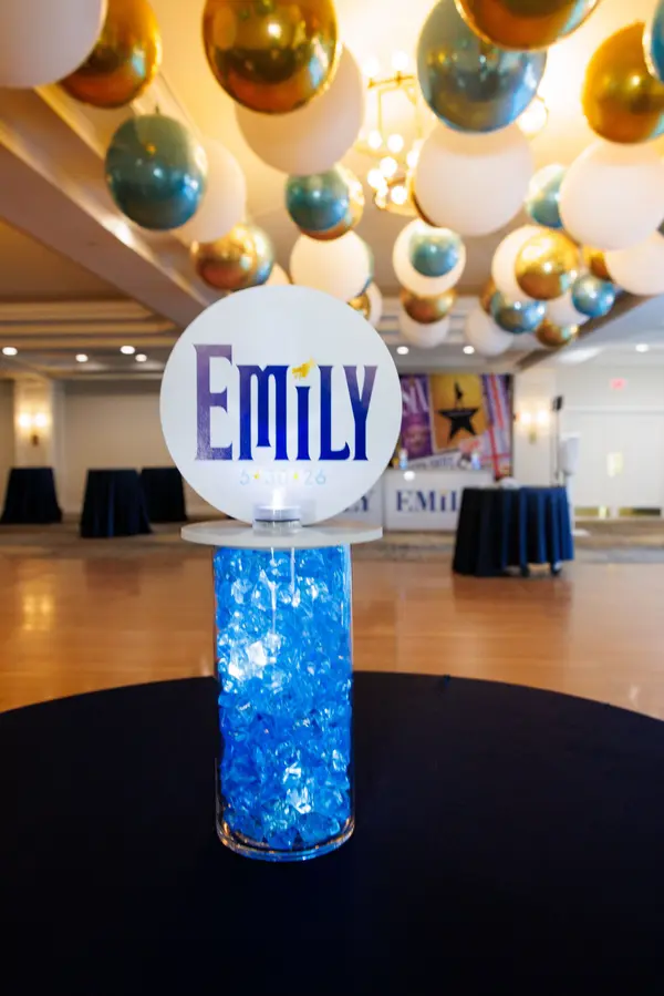 Emily's Bat Mitzvah round logo centerpiece on a blue gel cylinder