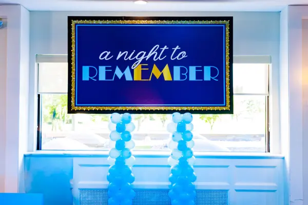 Emily's Bat Mitzvah A Night to Remember sign with blue balloon columns