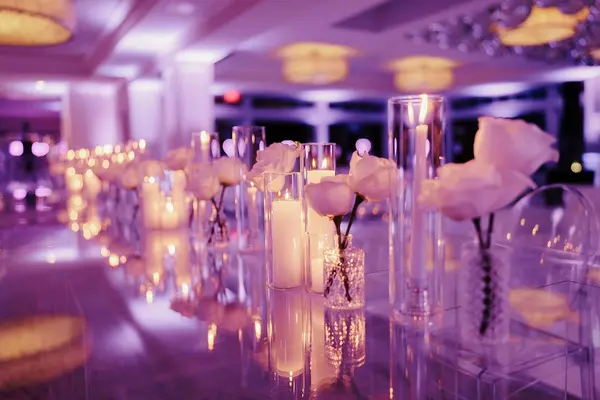 Ella's Bat Mitzvah white roses and pillar candles along a mirrored table