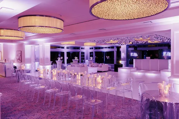 Ella's Bat Mitzvah mirrored kids table with ghost chairs under lavender lighting