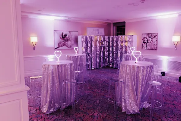 Ella's Bat Mitzvah sequin cocktail tables with neon hearts and favor wall