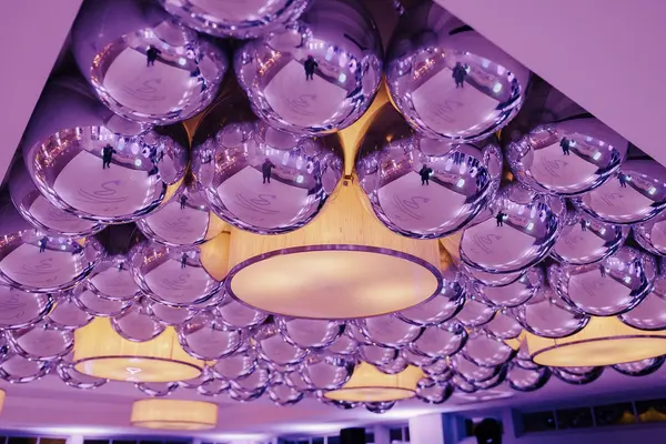 Ella's Bat Mitzvah silver orb balloon ceiling around drum chandeliers